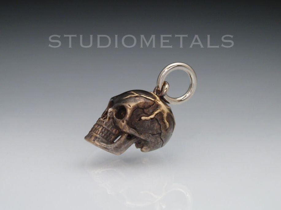 one of a kind gold veined skull pendant