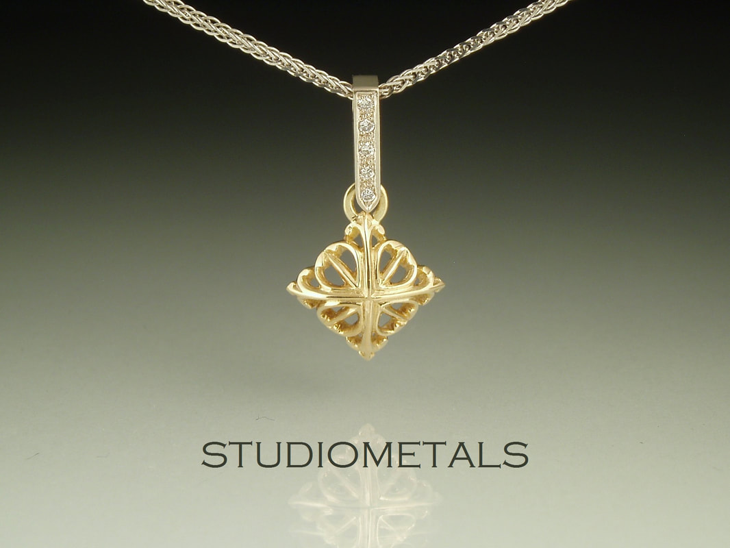 carved square pendant with pave set diamonds in 14k gold