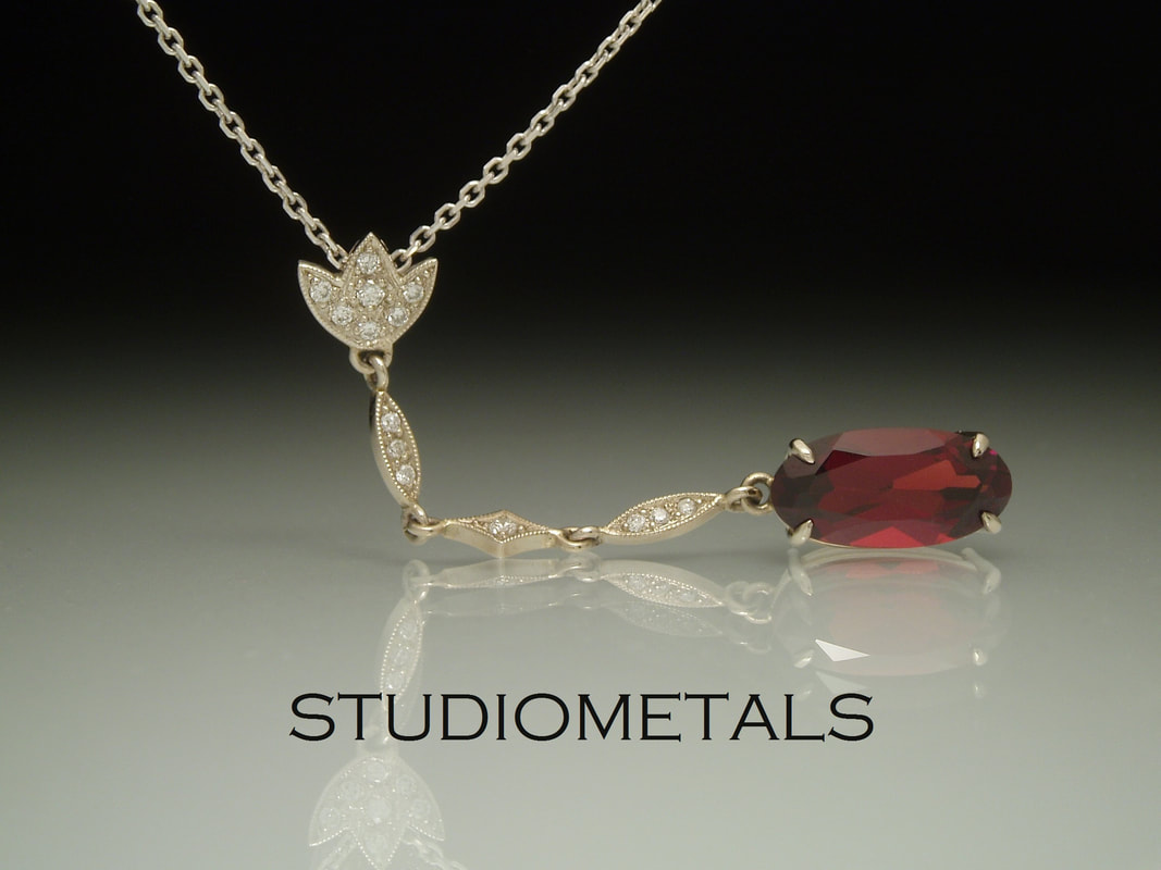victorian inspired red garnet and diamond pendant