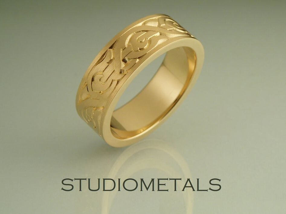 Hand engraved Nordic men's wedding ring in 18K yellow gold.