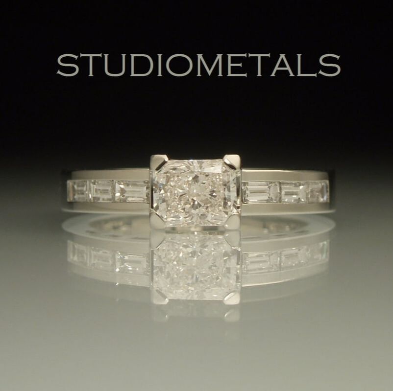 0.65 carat radiant cut ring with channel set baguette diamonds