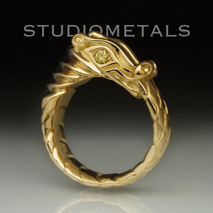 Hand carved, Nordic, ouroboros dragon ring in solid 18k yellow gold with natural yellow diamond eyes.