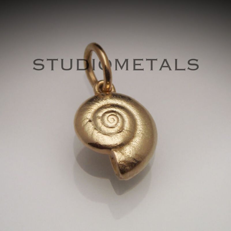 10mm spiral snail shell pendant in 14 karat yellow gold.