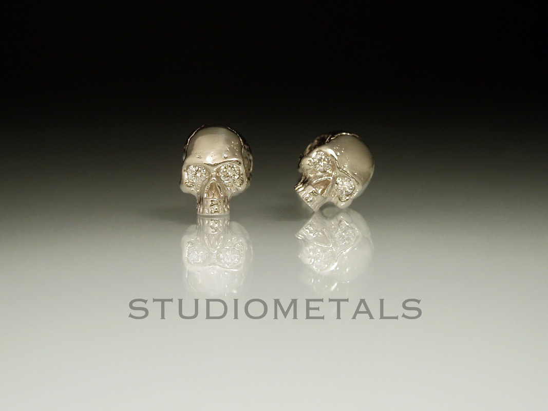 14k white gold half skull earrings with vs diamond eyes