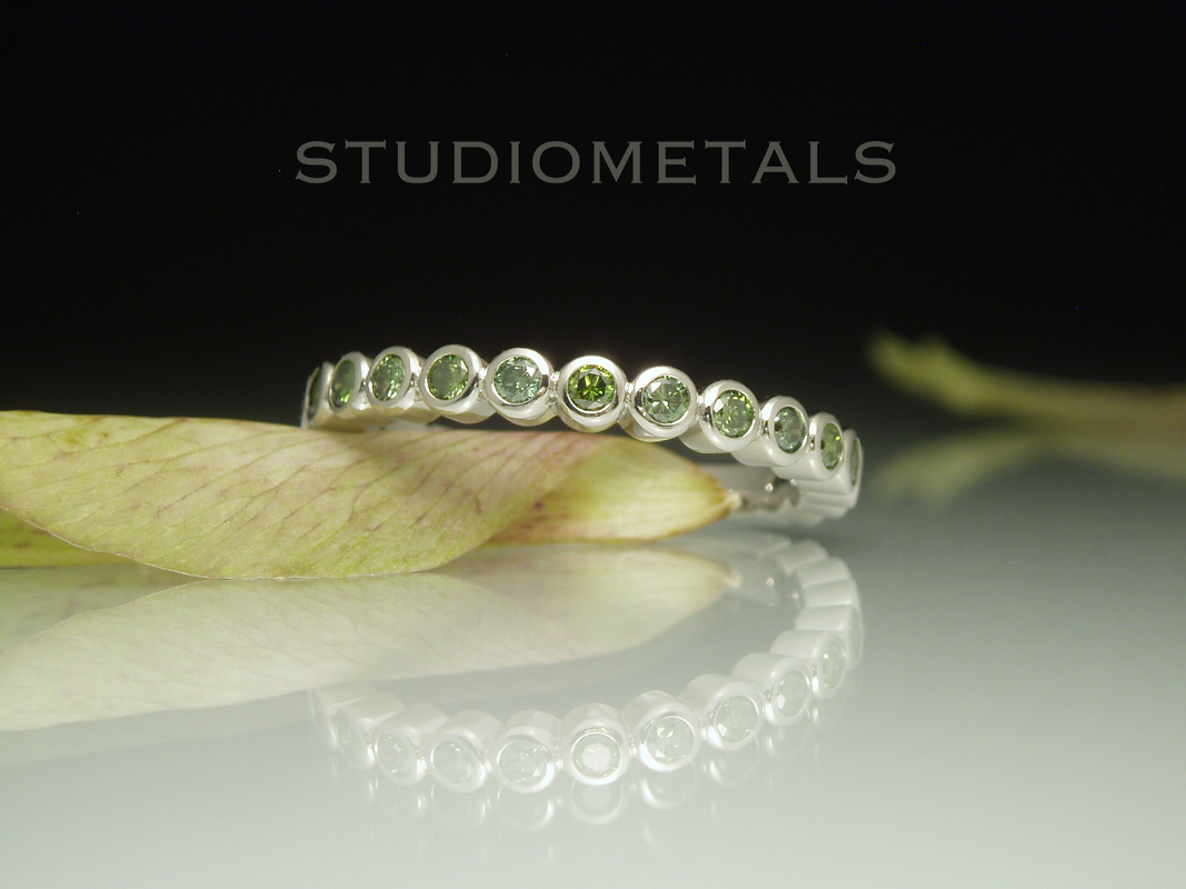 bezel set green diamond half eternity ring