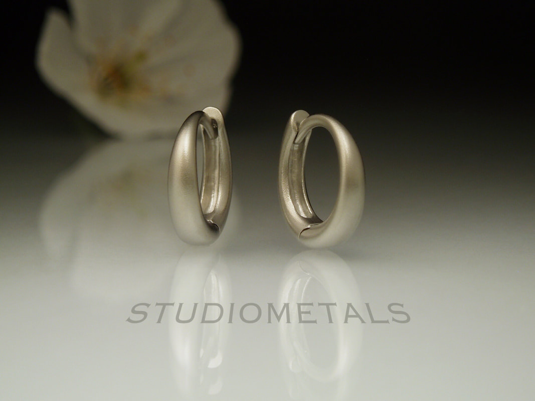 small matte white gold oval huggie hoops