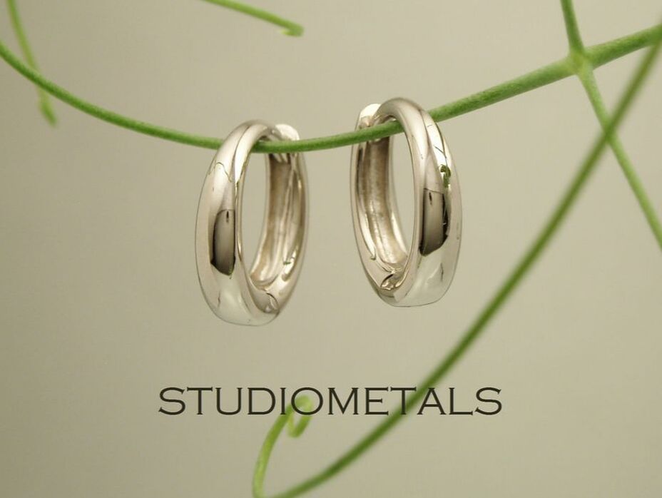 small oval hinged huggie hoops in white gold