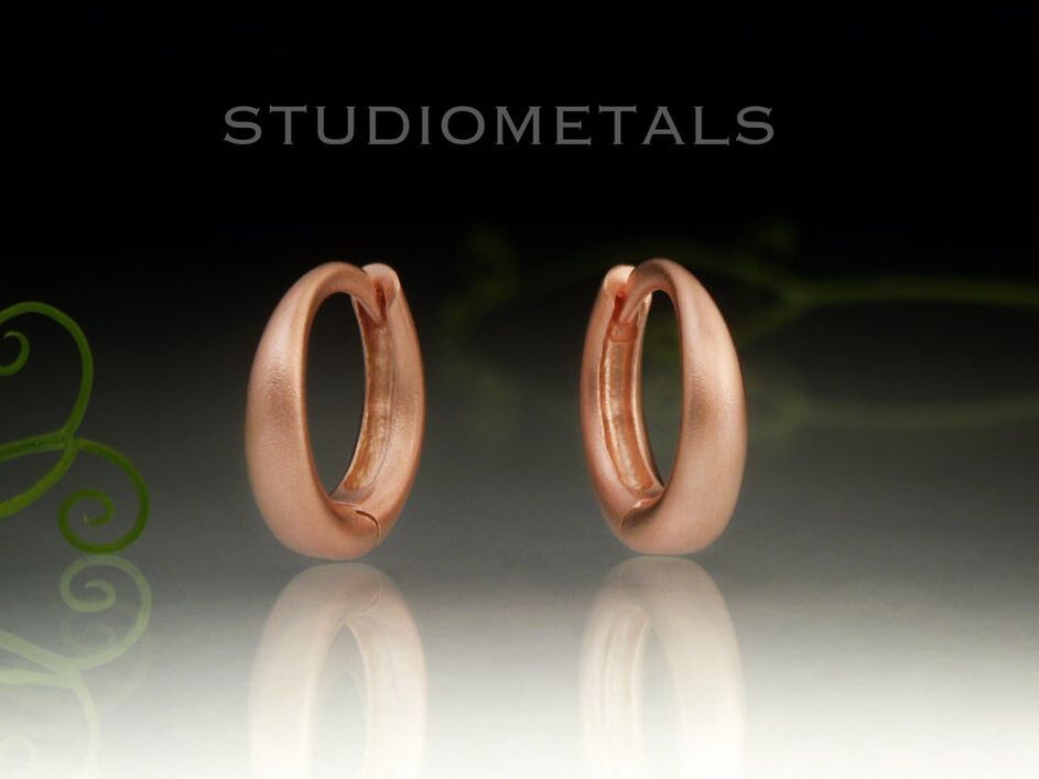 Tapered, 11mm oval huggy, clicker hoop earrings in real, solid 14 kt rose gold. 