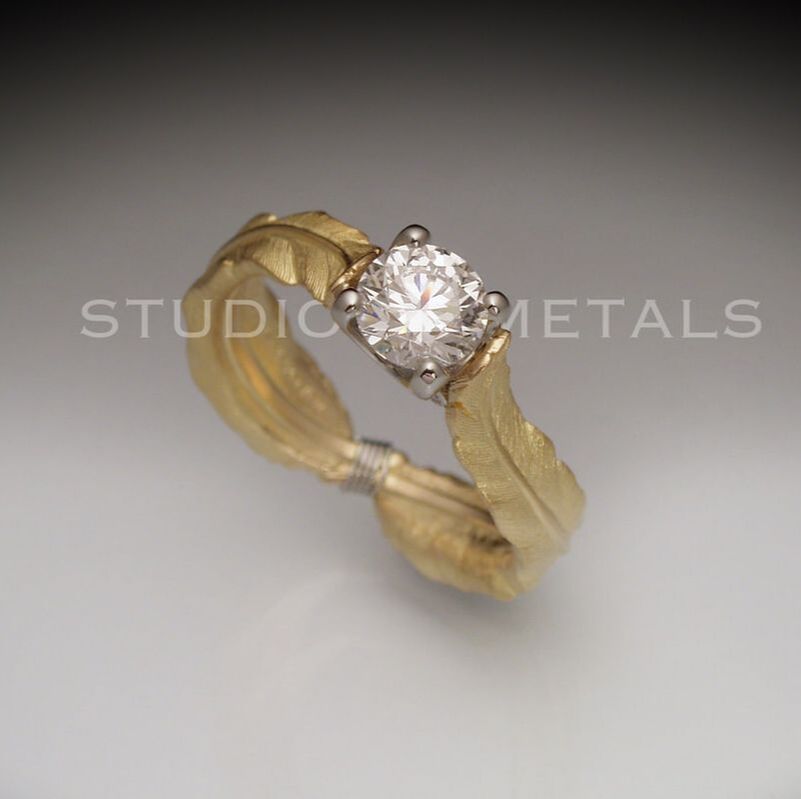 Artistic, wide feather diamond solitaire engagement ring. Natural Canadian 1 carat diamond ring in 18K gold.