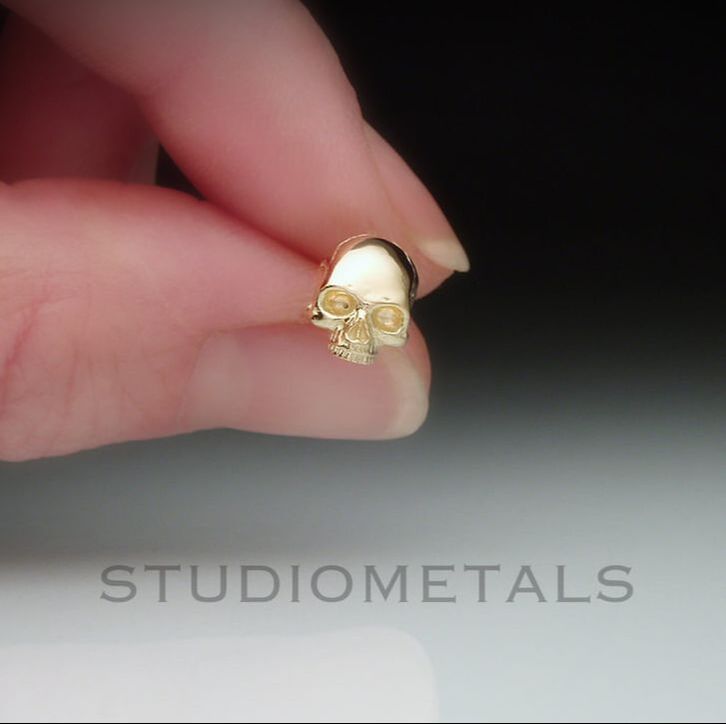 Single, 8mm jawless, half skull stud earring in 14 karat yellow gold.