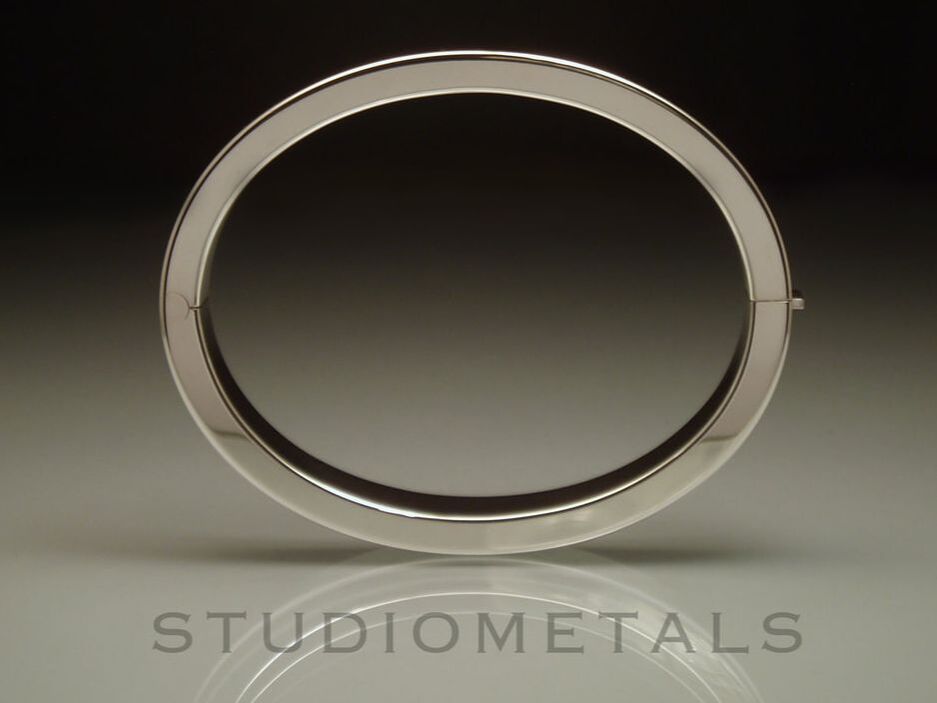 Solid, heavy, sterling silver hinged oval bangle bracelet for women.
