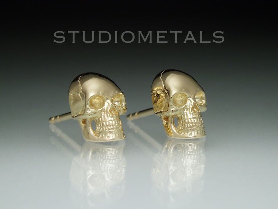 10mm full skull stud earrings in polished 14 karat yellow gold.