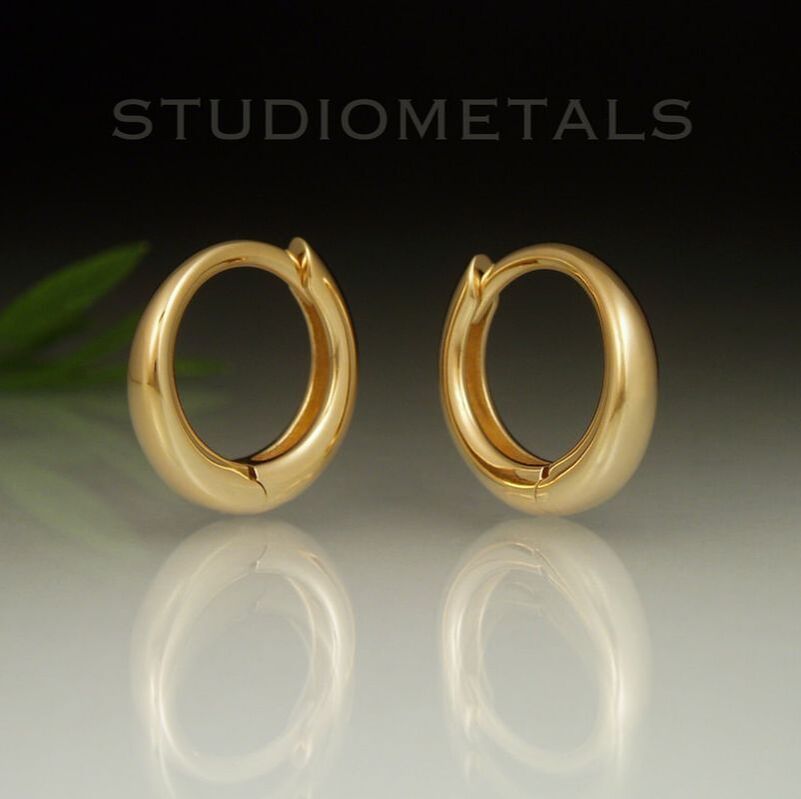 Tapered, 12mm round huggie hoop earrings in solid 18k yellow gold.