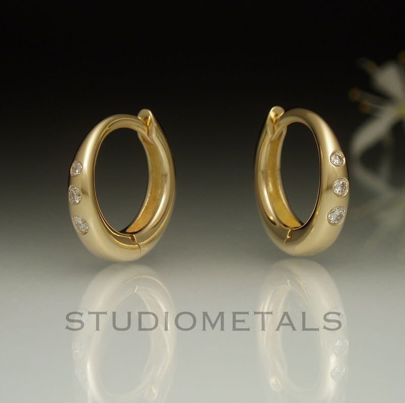 Solid 14k yellow gold 12mm diamond huggie hoop earrings.