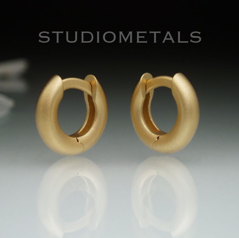 Tiny, 10mm outside diameter, 6mm inside diameter huggie hoop earrings in solid 18k yellow gold.