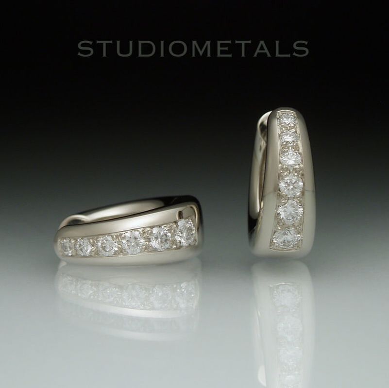 Wide tapered, 13mm oval huggie hoop earrings pave set with natural, VS diamonds.