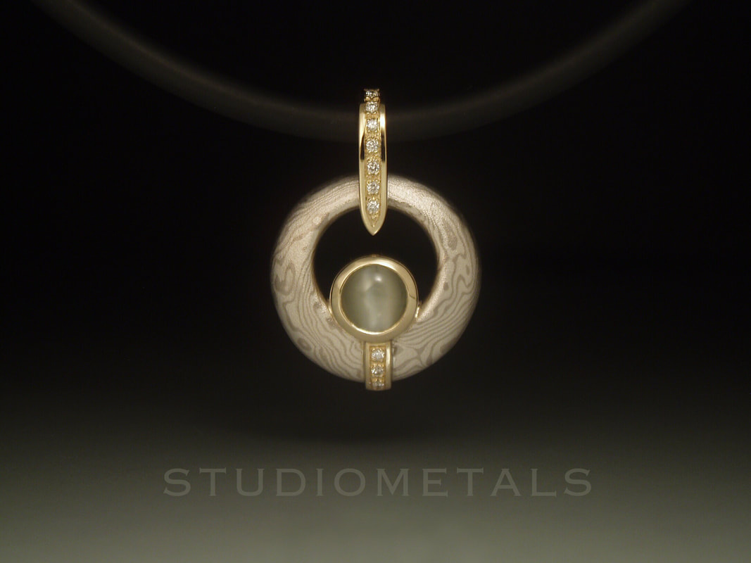 mokume gane pendant featuring cat's eye chrysoberyl, diaonds and 14k gold