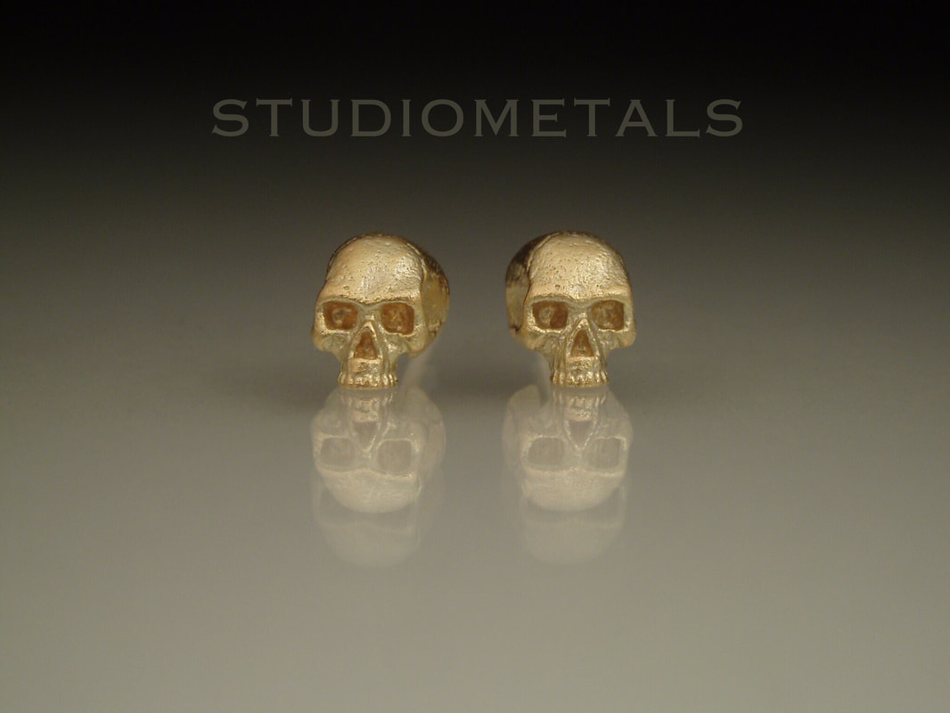 half skull earrings in 14k gold