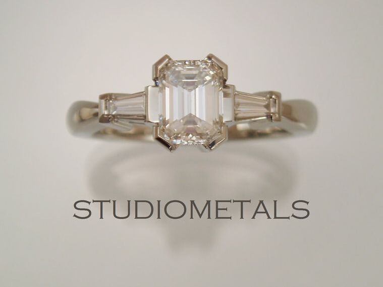 emerald cut three stone engagement ring