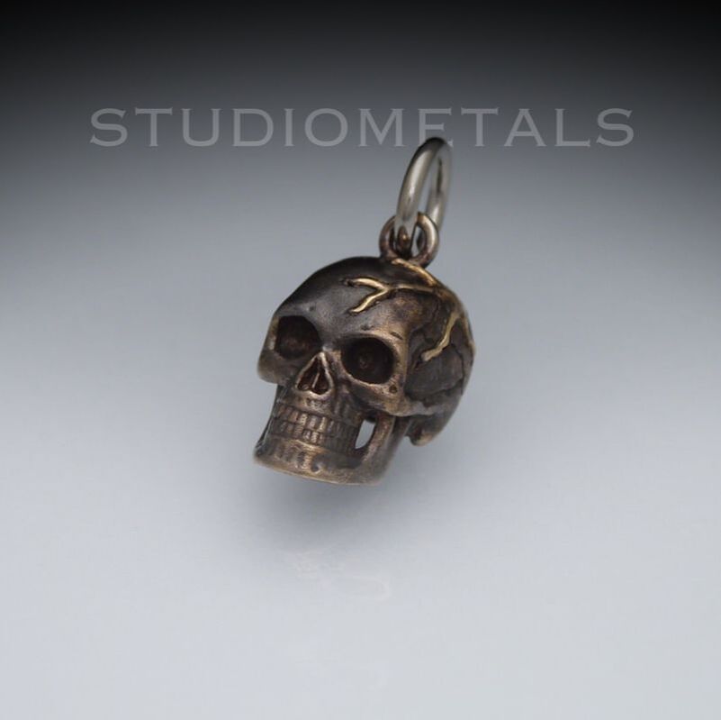 10mm blackened, 14k white gold skull with 18k yellow gold veins.