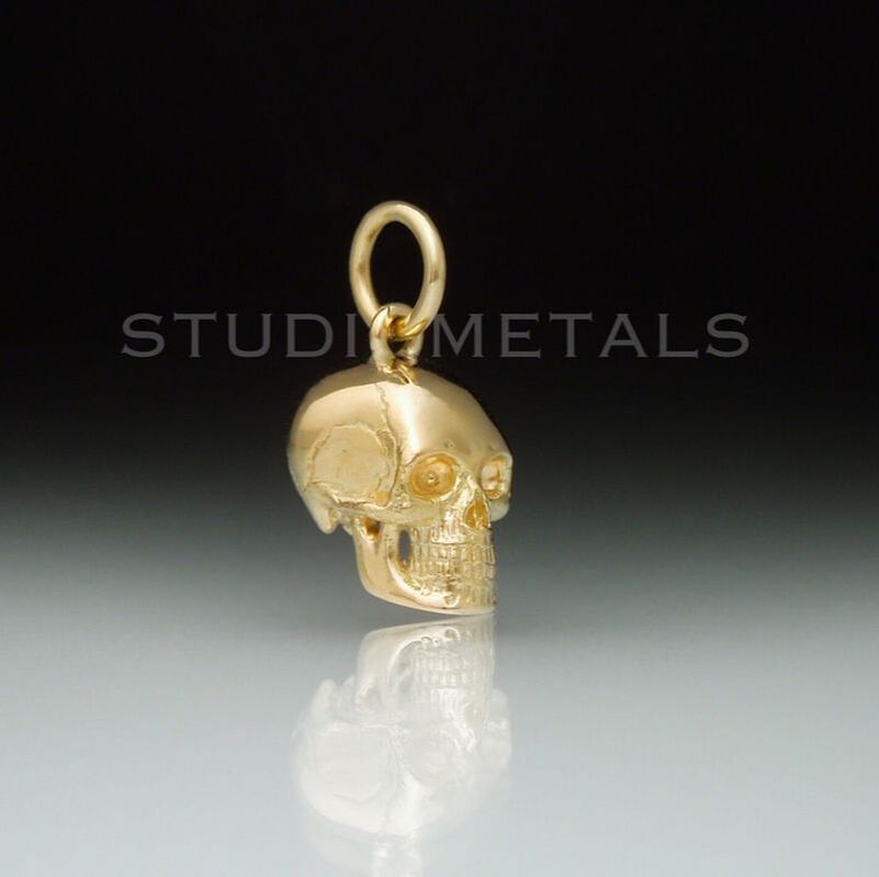 solid 14k yellow gold realistic skull pendant