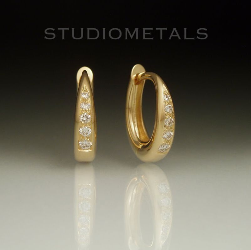 Bead set diamond huggie hoop earrings in 18 karat yellow gold.