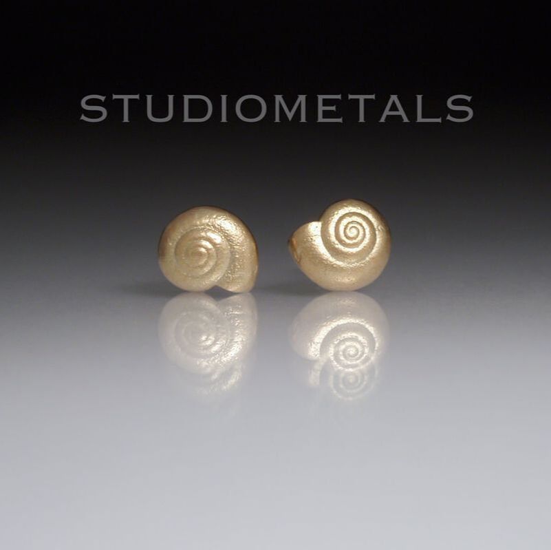 Matte 14k yellow gold spiral snail shell stud earrings.