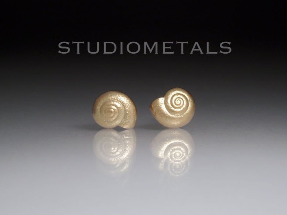 Organic, 14 karat yellow gold spiral snail shell stud earrings.