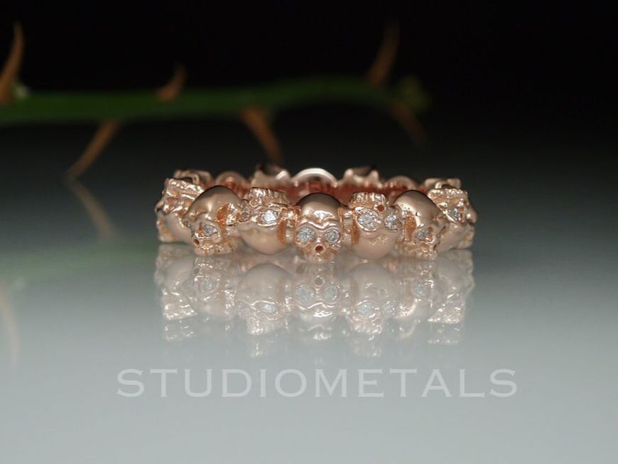 14k rose gold women's skull eternity ring with vs diamond eyes.