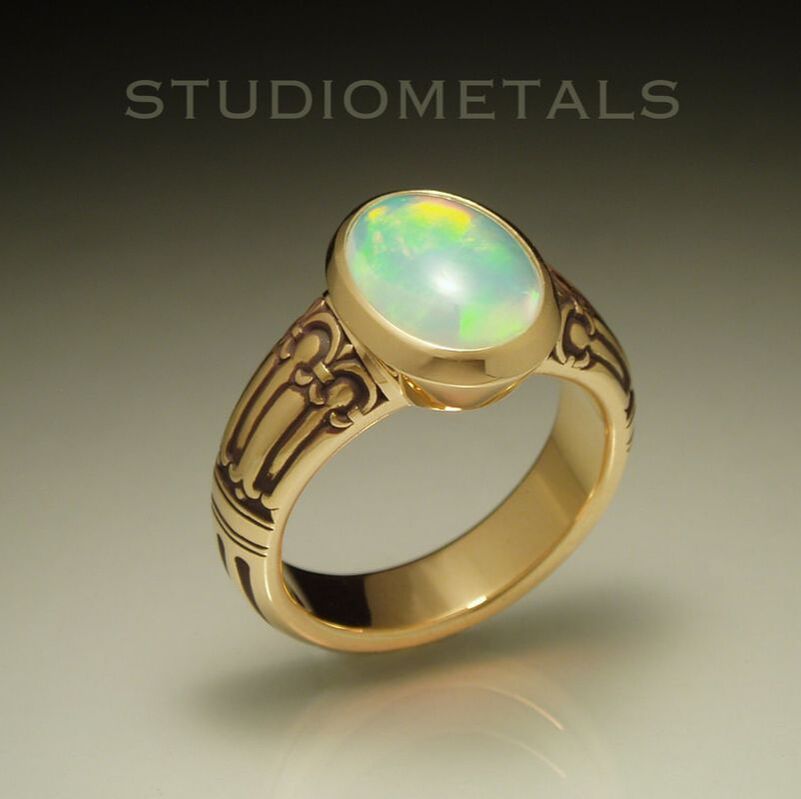 Hand carved 18 karat yellow gold men's ring with large oval opal.