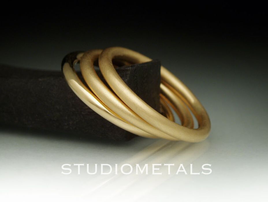 Simple, 2mm round stacking bands in solid 18k yellow gold. 