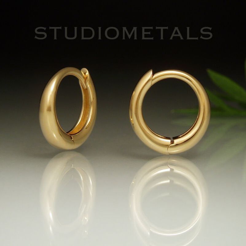 Hinged 12mm round sleeper huggie hoops in solid 18 karat gold.