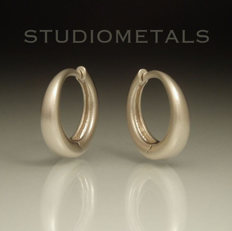 Brushed 14k white gold 16mm diameter hinged hoop earrings.