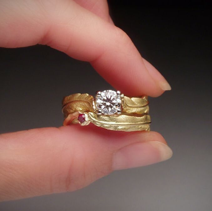 Hand carved 18k feather, 1 carat diamond engagement ring and matching wedding band.
