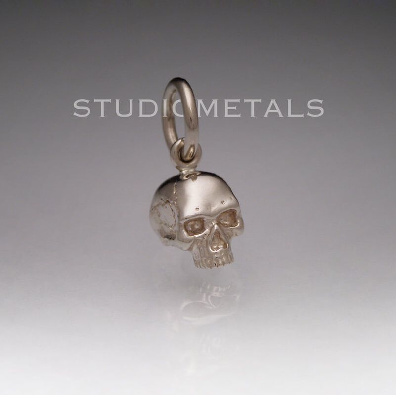 Solid 14k gold, 6mm jawless half skull charm pendant.