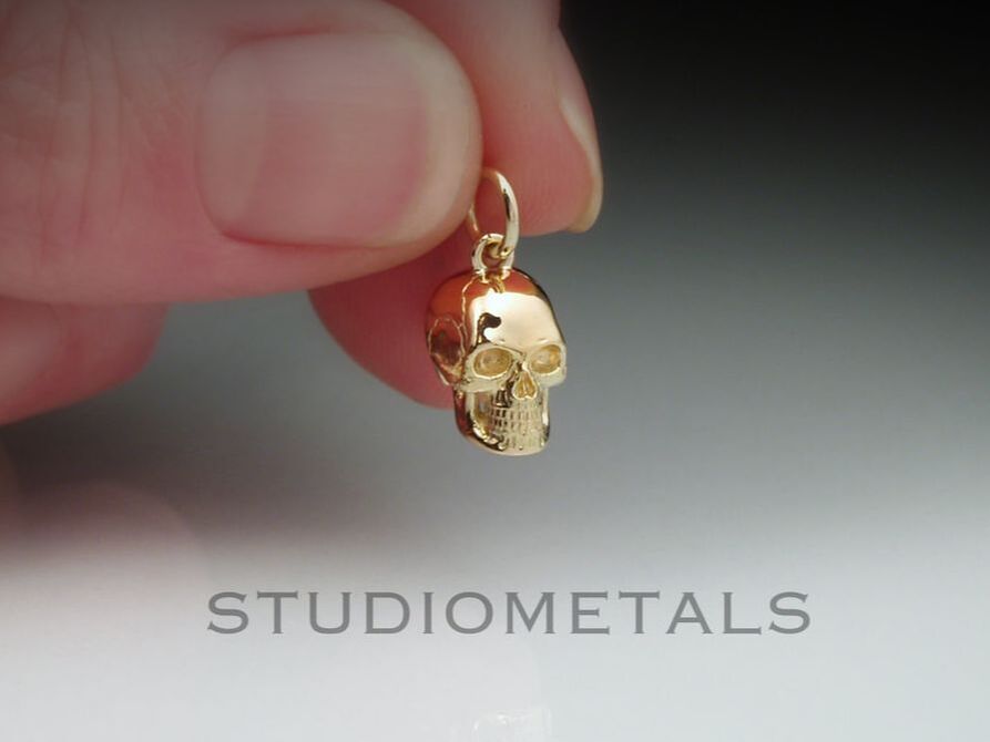 Realistic, 10mm skull pendant in 14k yellow gold.