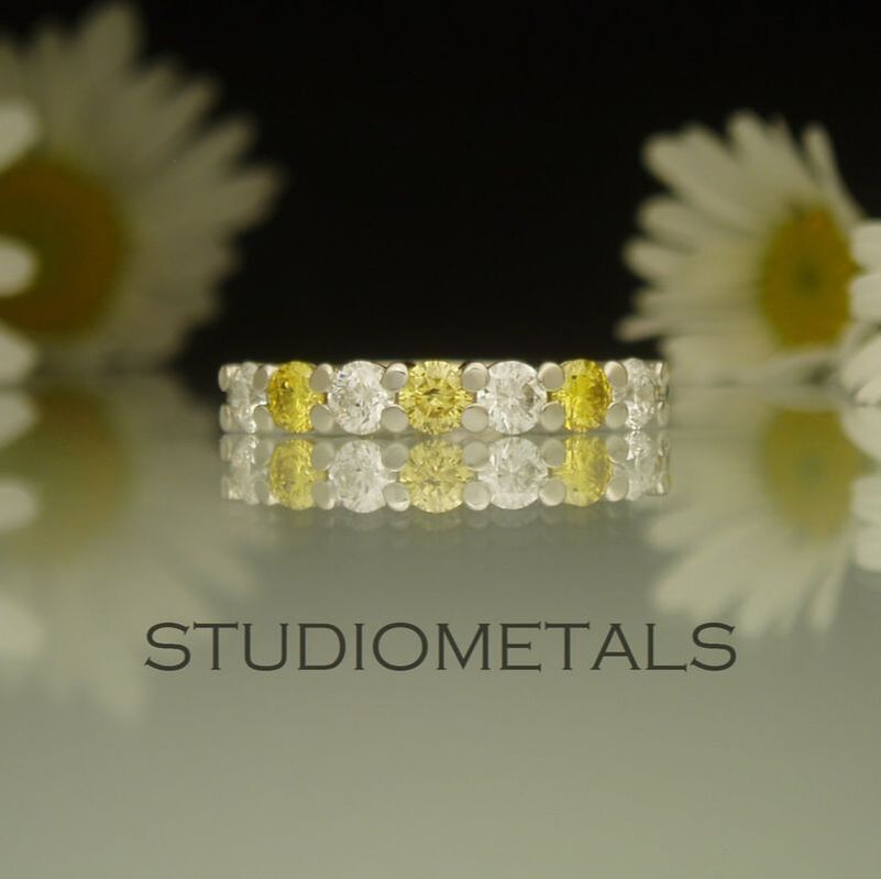 Prong set seven diamond, women's wedding ring in 19K white gold.