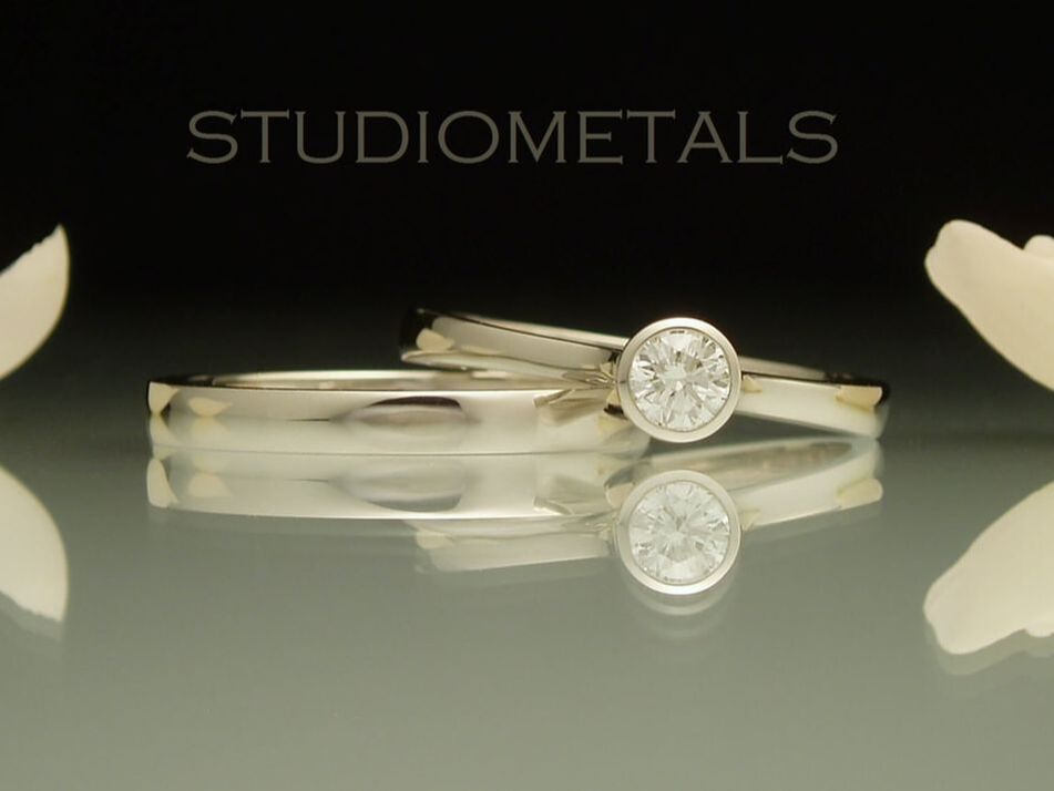0.2 carat diamond bezel engagement ring with matching wedding band