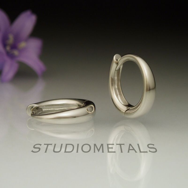 tiny 11mm oval huggies in polished 19k white gold