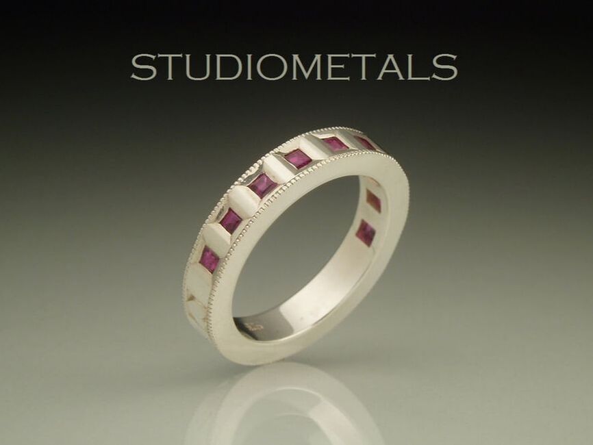 hand engraved sterling silver love ring with flush set square rubies