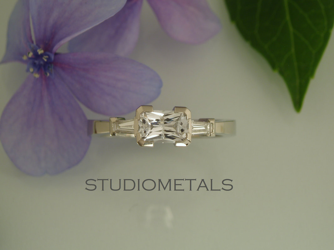 horizontal radiant cut white sapphire engagement ring