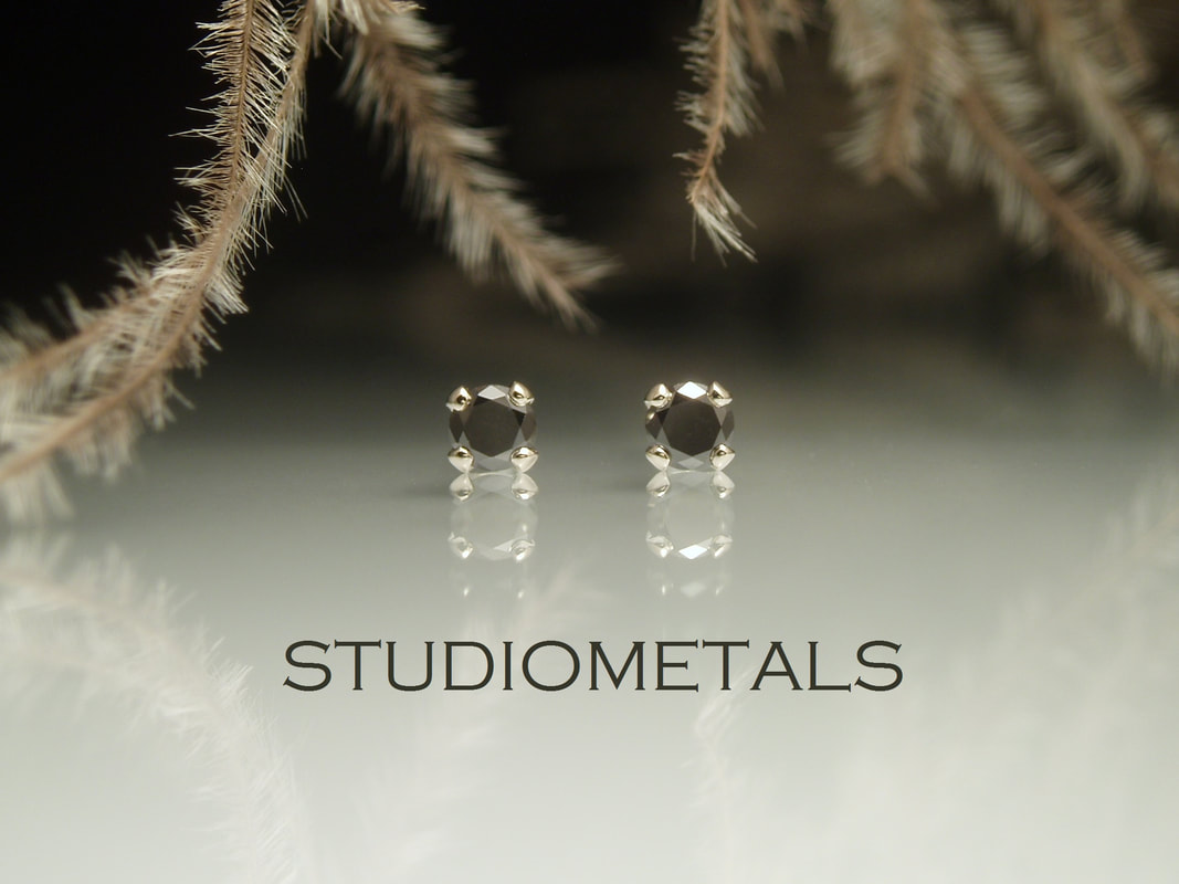 small black diamond stud earrings in 14k gold