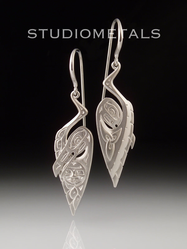 West coast hand carved dangle earrings in 19k white gold, Raven Steals the Moon.