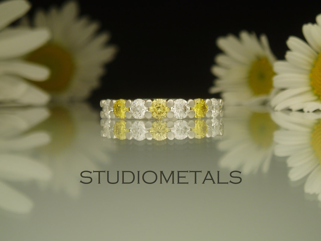 Alternating yellow and white, seven, diamond wedding ring 